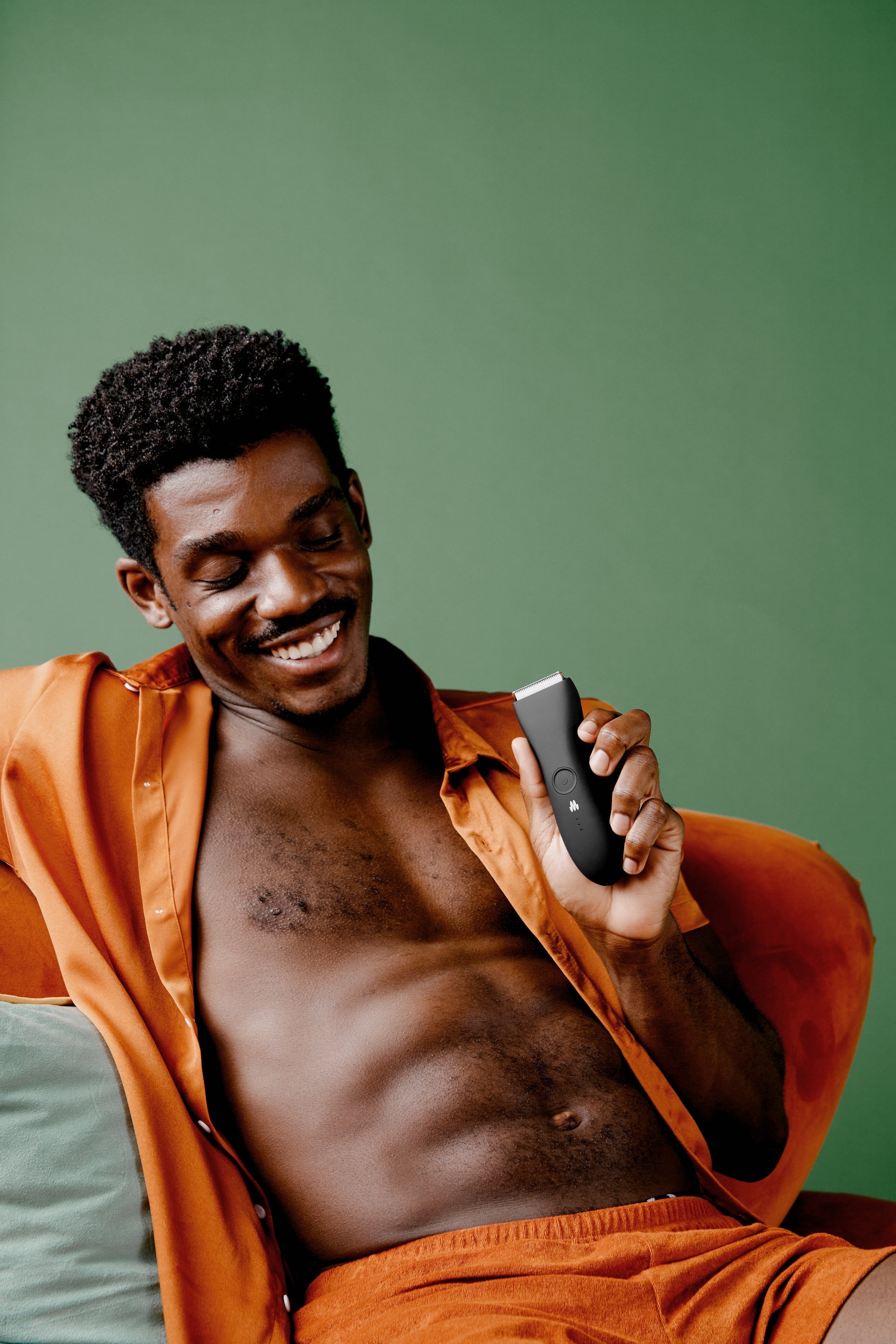 man holding body groomer for private parts