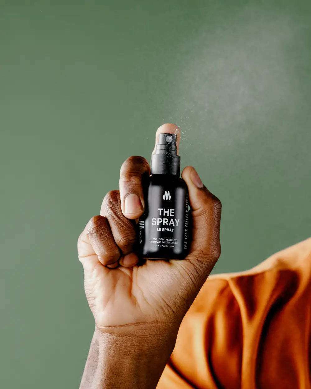 Person spraying Meridian's The Spray body deodorant